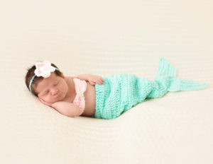 Sweet newborn girl posed at our in home studio in Rochester, Ny.