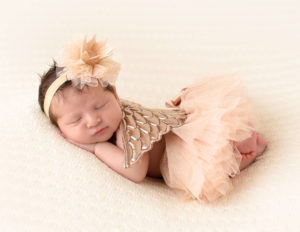 Angel newborn girl posed in our Rochester, Ny studio.