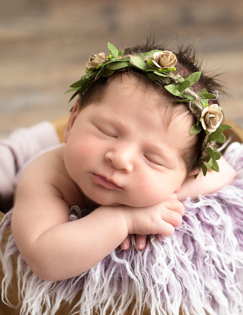 Newborn girl posed in Rochester, Ny at our studio.