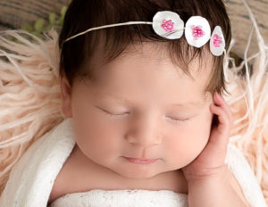 Sweet newborn girl sleeping in our Rochester, Ny studio.