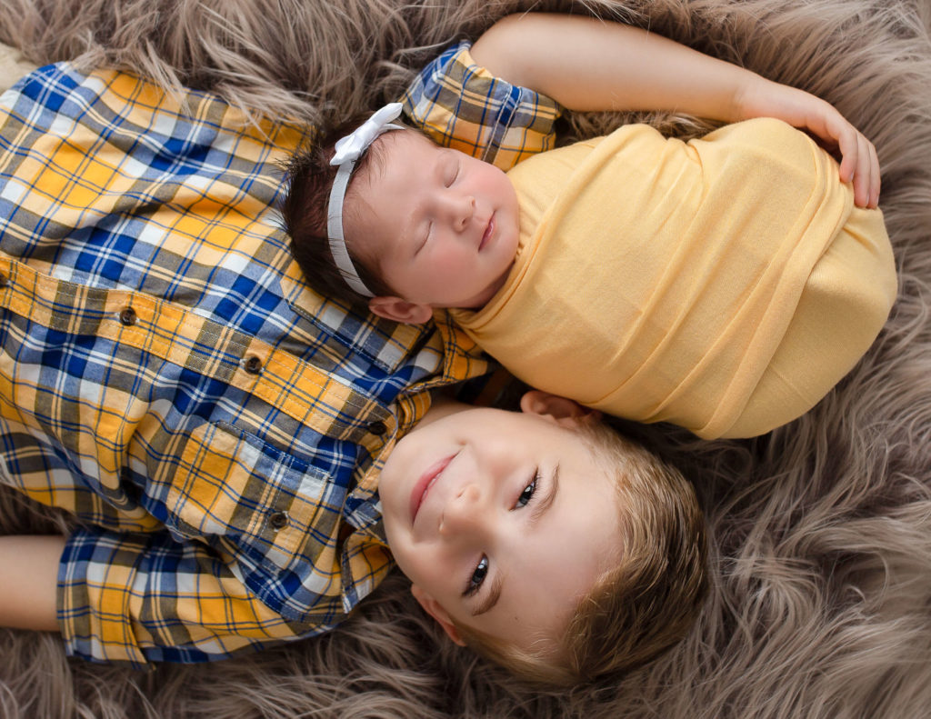 Siblings posed in our in-home Newborn Rochester, Ny studio.