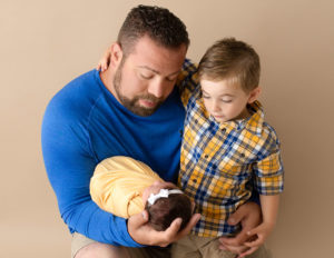 Father, son and newborn daughter posed in our studio in Rochester, Ny.