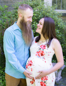 Pregnant couple posed in Rochester, Ny Highland Park.