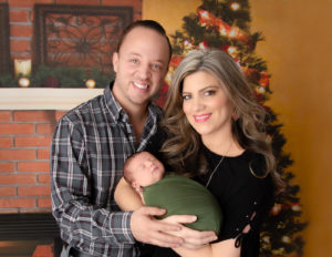Parents posed with adorable newborn boy at our Rochester, NY studio. 