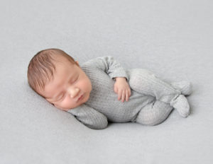 Cute newborn boy posed in our Rochester, NY studio..
