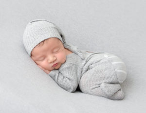 Sleeping newborn boy posed in our studio in Rochester, NY.