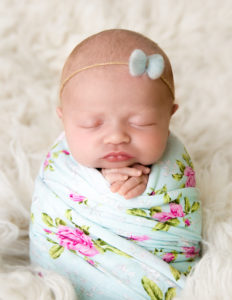 Sweet newborn girl posed at our Rochester, Ny studio.