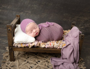 Adorable newborn girl posed in our Rochester, NY studio.