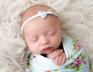 Sleeping baby girl posed in our studio in Rochester, NY.