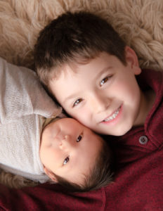 Siblings posed at our newborn studio in Rochester, NY.