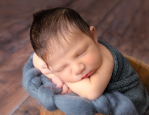 Cute newborn boy posed in our studio in Rochester, NY.