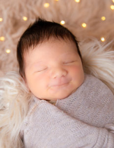 Smiling baby boy posed at our Rochester, NY studio.