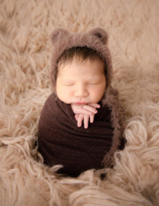 Adorable newborn boy posed in our studio in Rochester, NY.