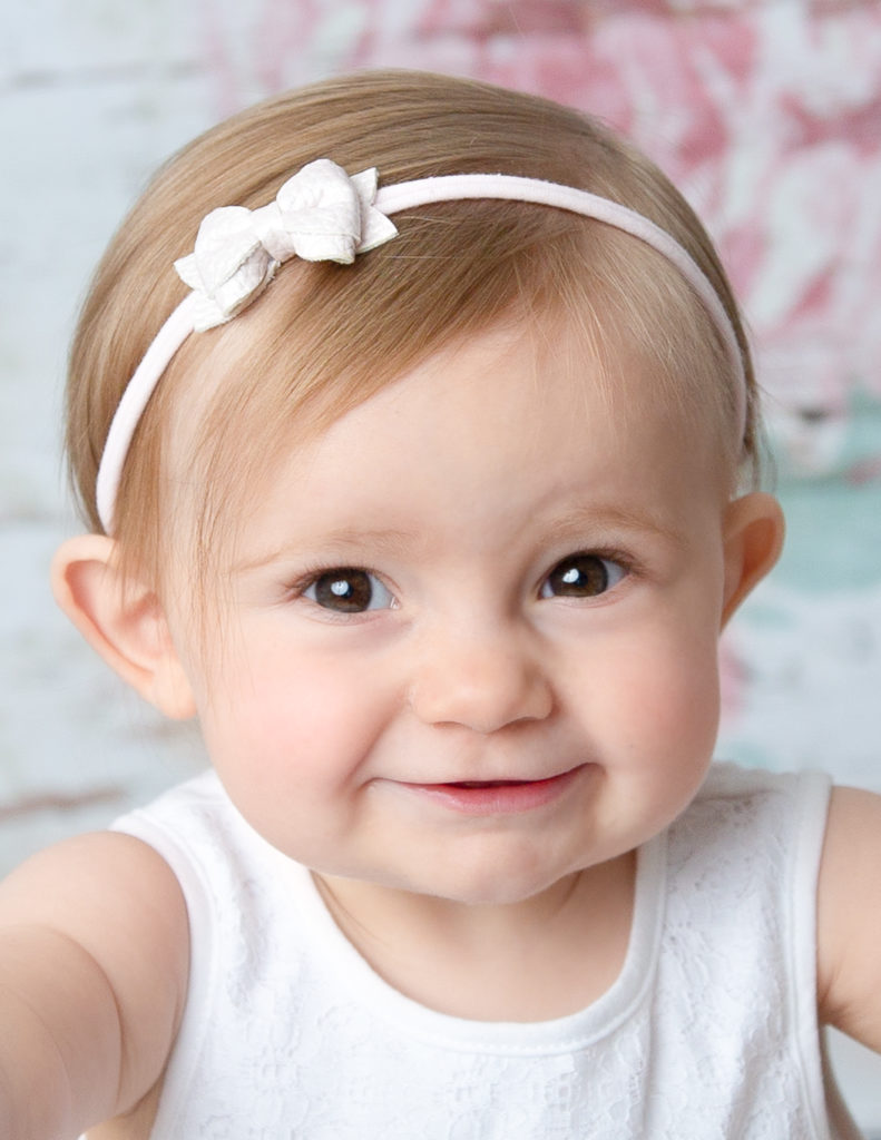 Smiling one year old at our Rochester, Ny studio.