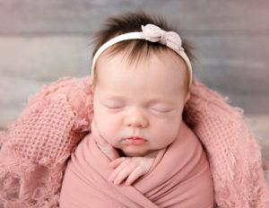 Sleeping newborn girl at our in-home Rochester, Ny studio.