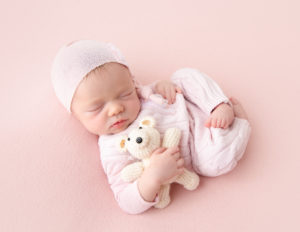 Sleeping newborn girl at our in-home Rochester, Ny studio.