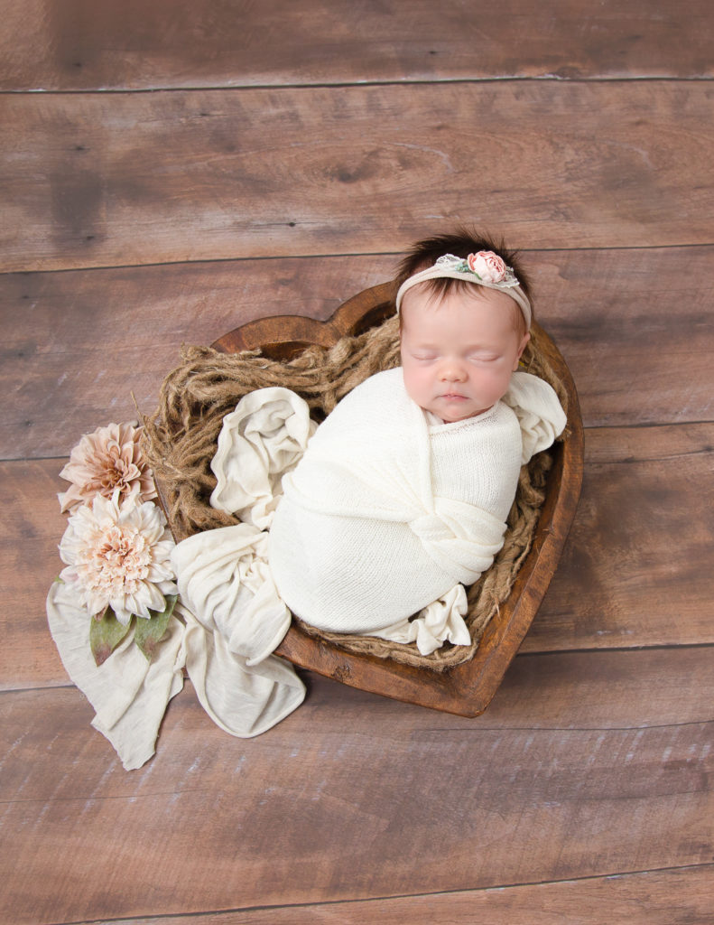 Adorable baby girl posed in our Rochester, Ny studio.