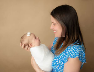 Mom and newborn posed at our in-studio Rochester, NY studio.