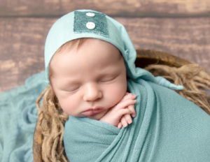 Posed sleeping newborn at our Rochester, NY studio.