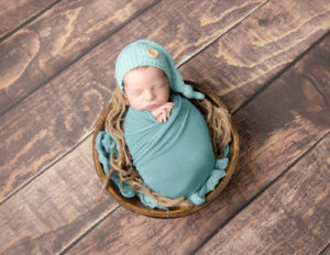 Newborn boy posed at our in-home Rochester, NY studio.