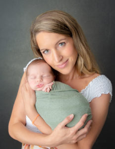 Mother and newborn posed at our in-home studio in Rochester, NY.