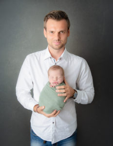 Father and newborn posed at our Rochester, NY studio.