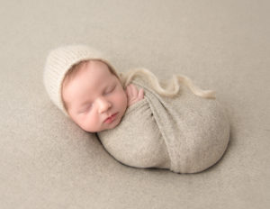 Cute newborn boy posed at our Rochester, NY studio.