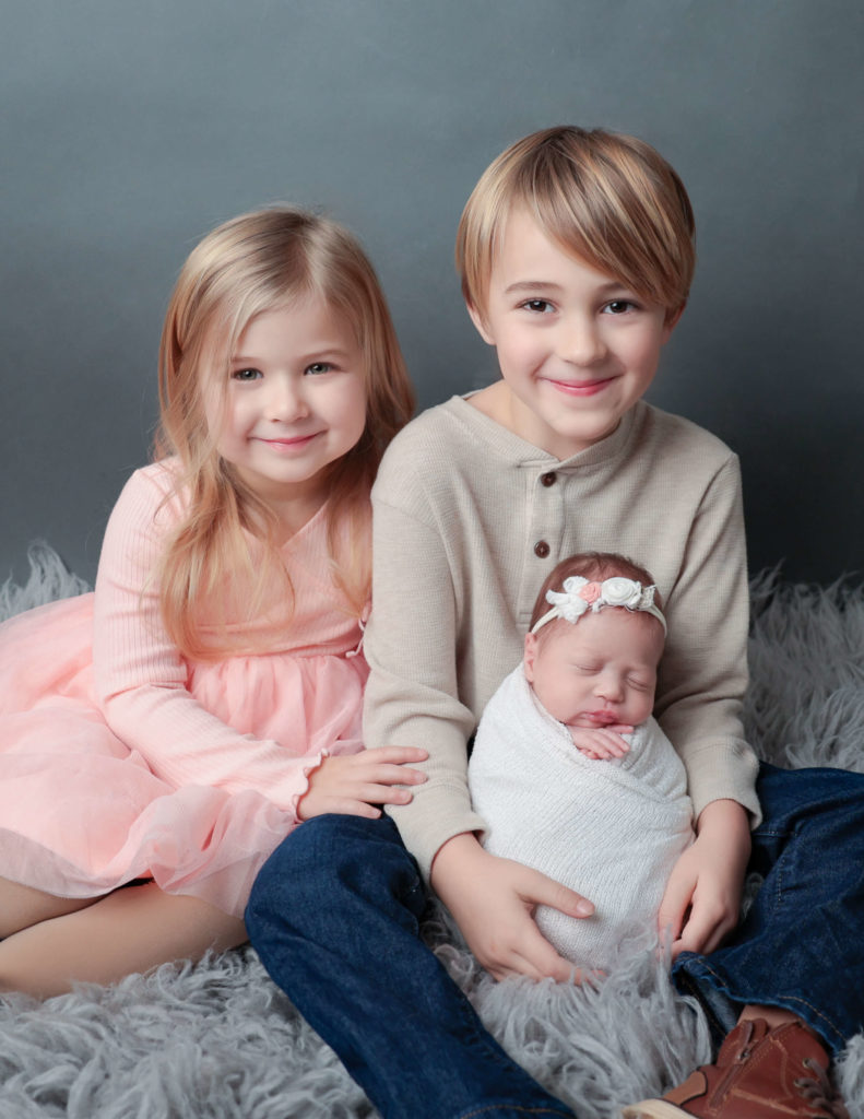 Siblings posed at our Newborn family session in Rochester, NY.