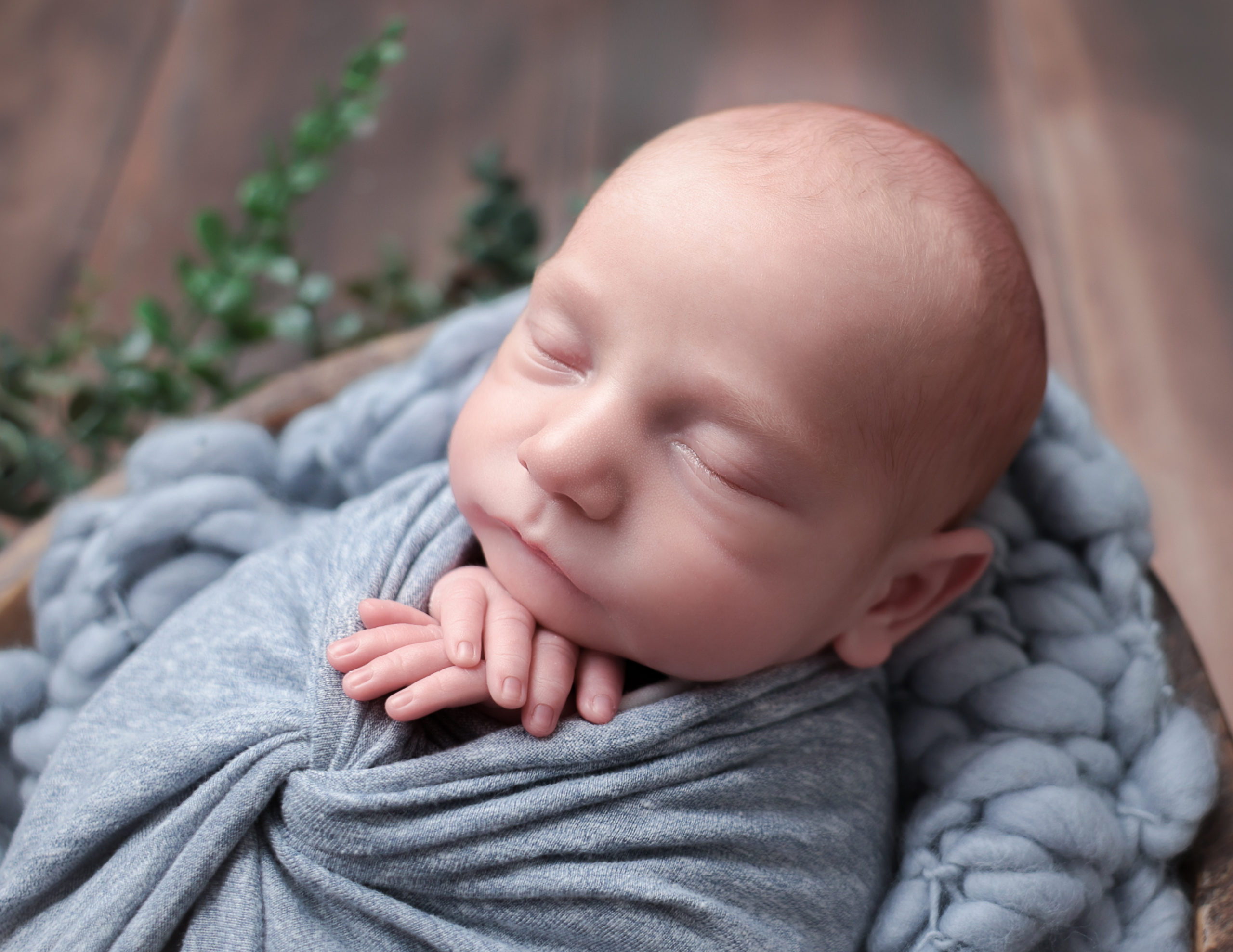 Sweet newborn boy posed at our Rochester, NY studio.