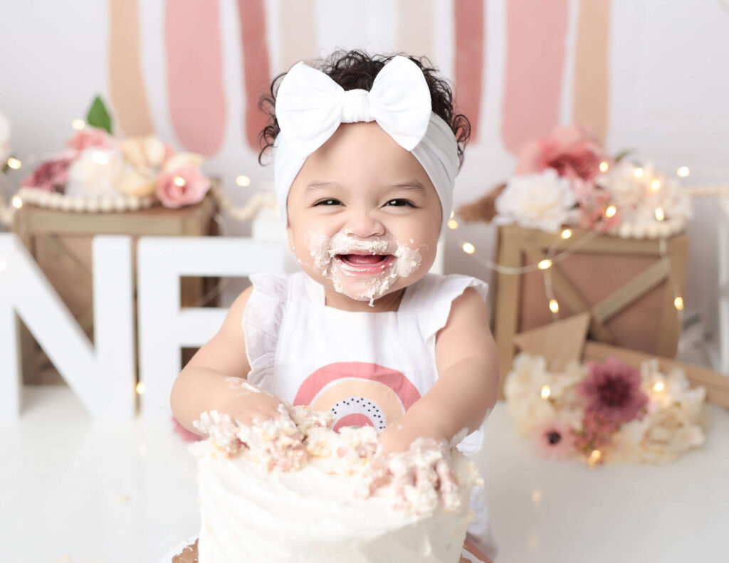 Happy girl at her cake smash